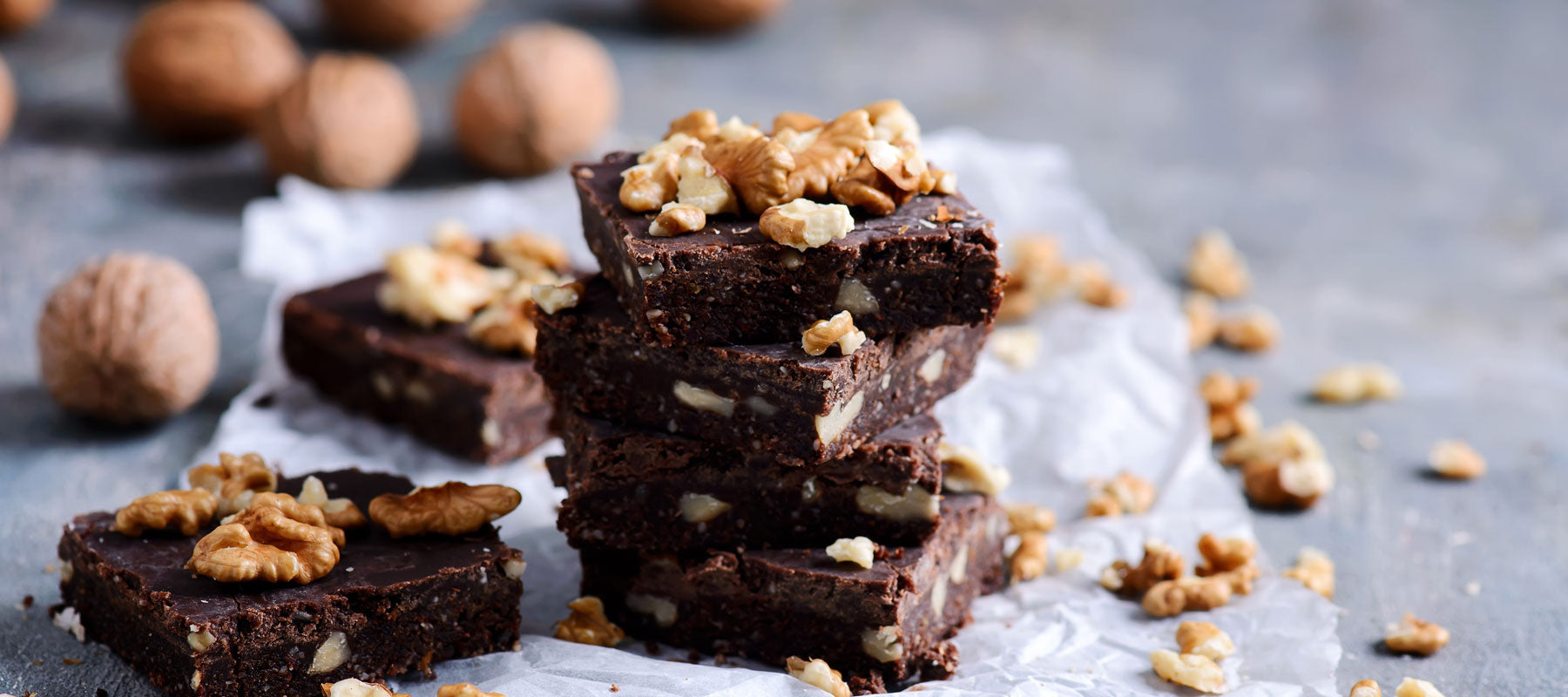 decoratively displayed bites of chocolate and nut no bake vegan brownies