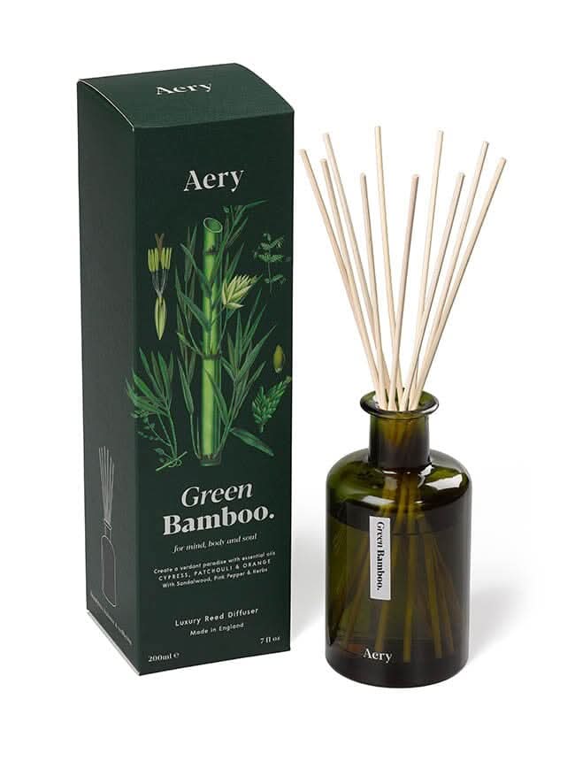 Green Bamboo diffuser by aery displayed next to product packaging on white bacground