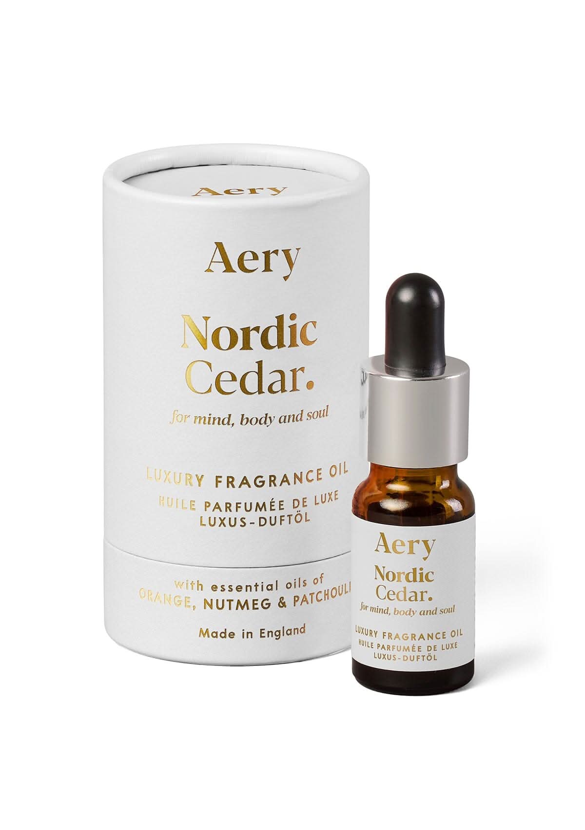 White Nordic Cedar fragrance oil displayed next to product packaging by Aery on white background