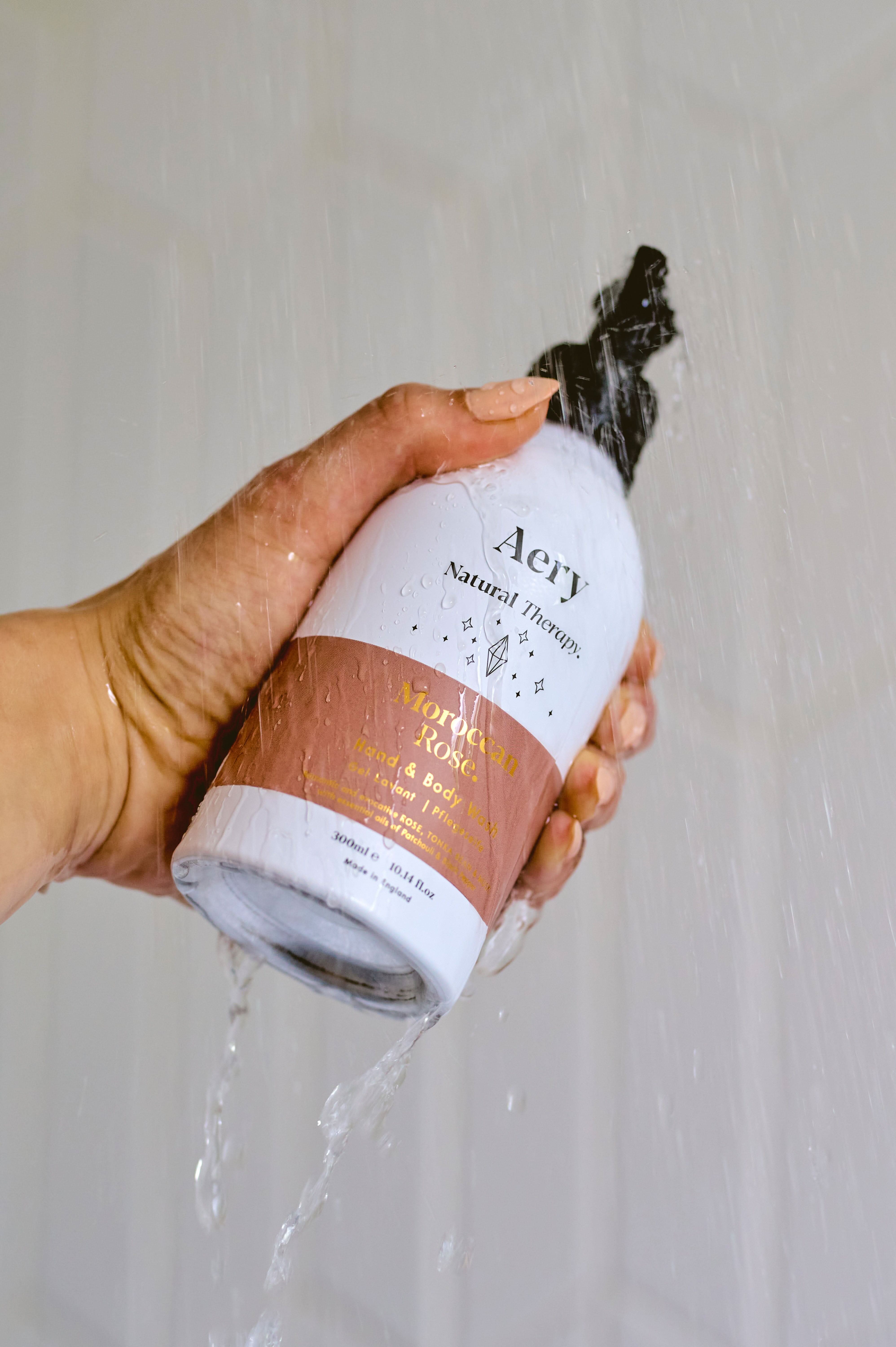 Aubergine Moroccan Rose hand wash by Aery displayed in hand in shower