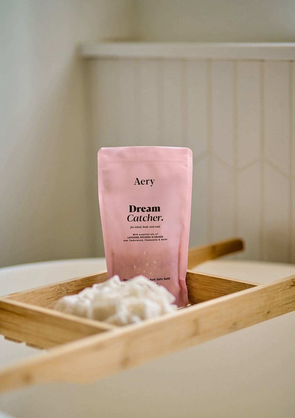 Lilac Dream Catcher bath salts pouch displayed on wooden bath try in bathroom