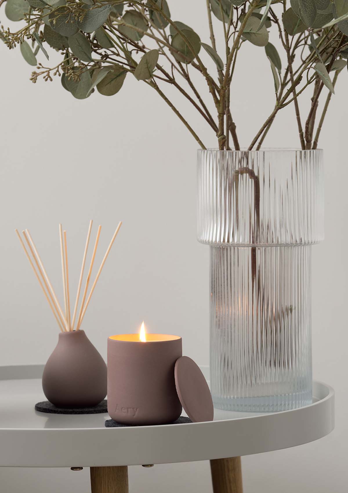 Aubergine Moroccan Rose Diffuser by Aery displayed next to Moroccan Rose candle on grey table