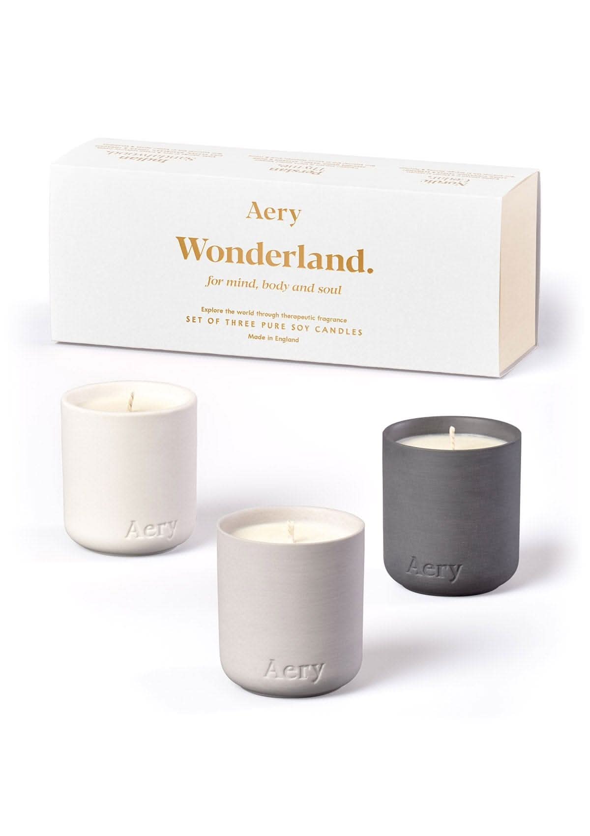 White Wonderland candle set of three displayed next to product packaging by Aery on white bacground