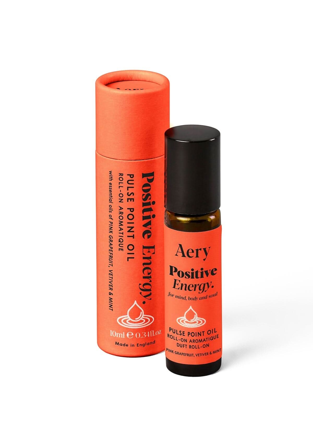 Red Positive Energy pulse point roll on oil next to packaging on white background