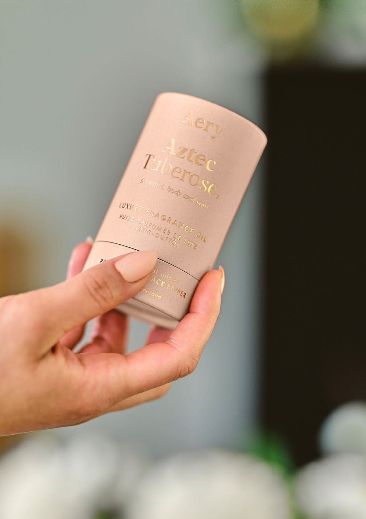 Pink Aztec Tuberose fragrance oil product packaging by Aery displayed in hand