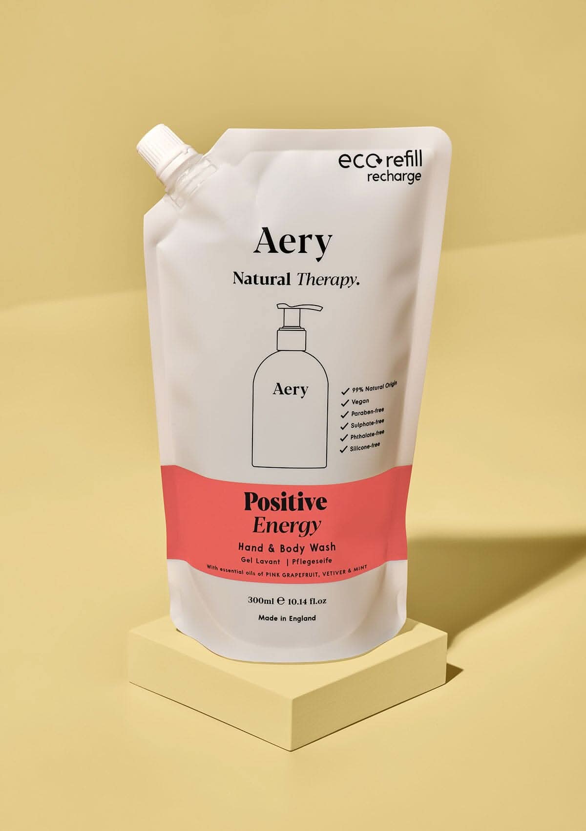 Red Positive Energy hand and body wash refill pouch by aery on yellow background