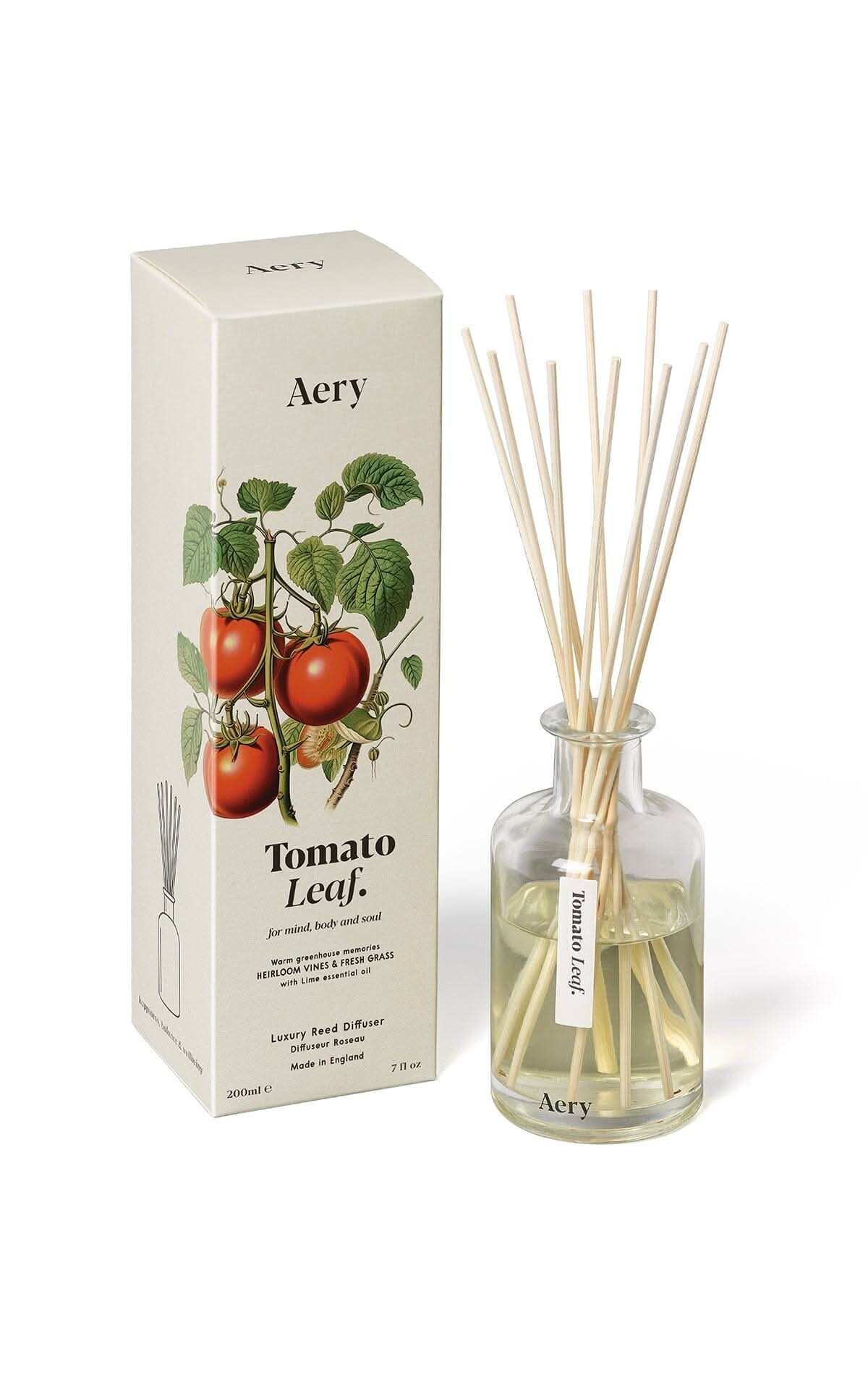 tomato leaf reed diffuser displayed next to decorative illustrated packaging
