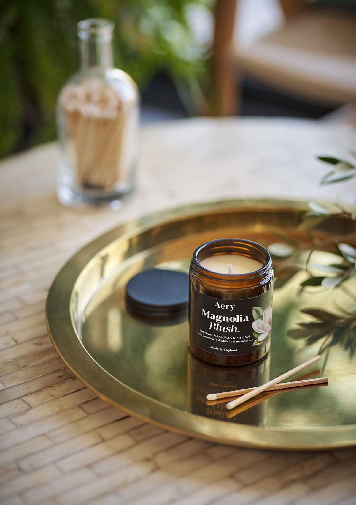 Magnolia Blush jar candle by Aery on gold tray with match sticks