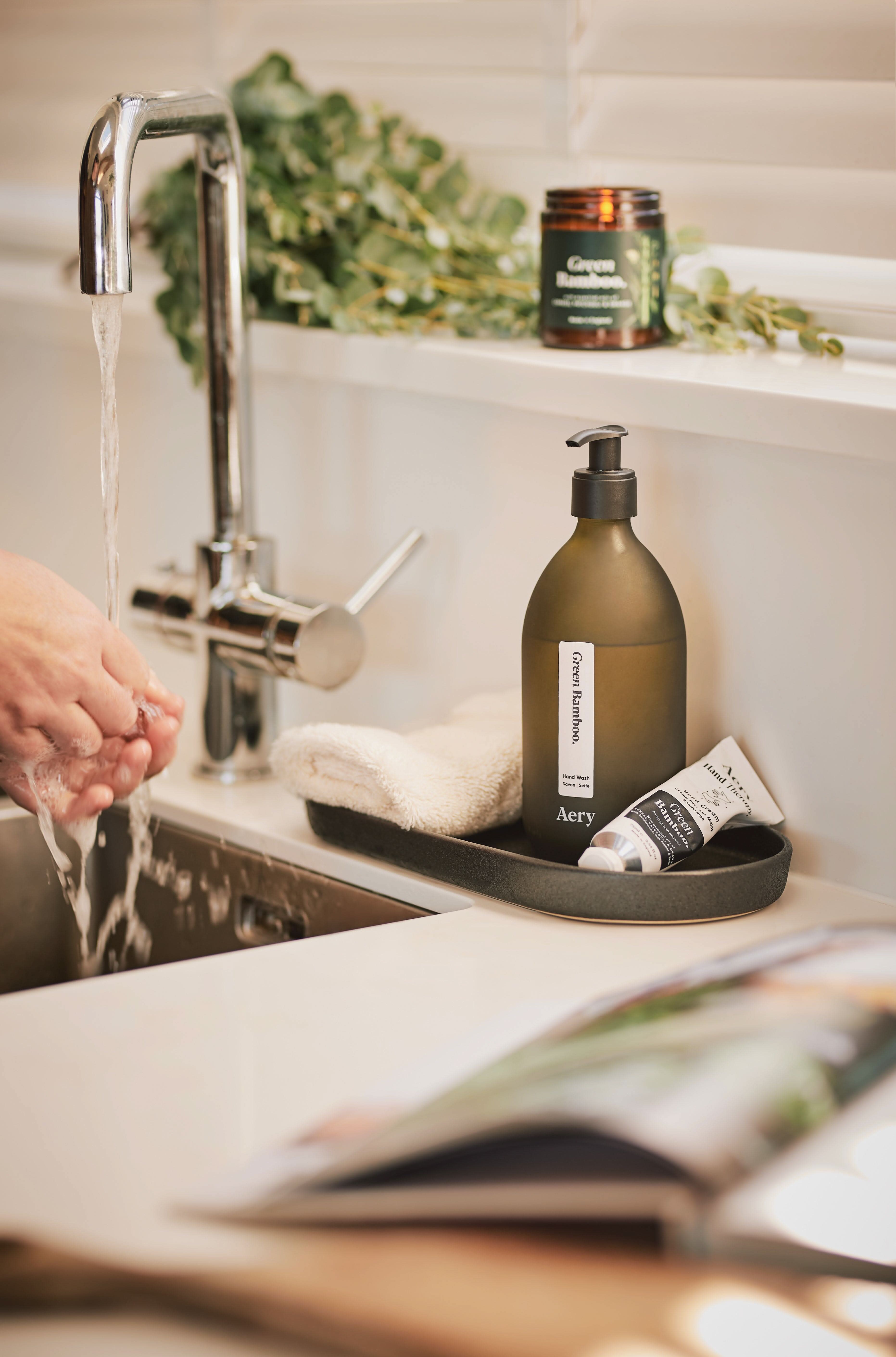 Green Bamboo Hand wash and cream by Aery displayed next to kitchen sink